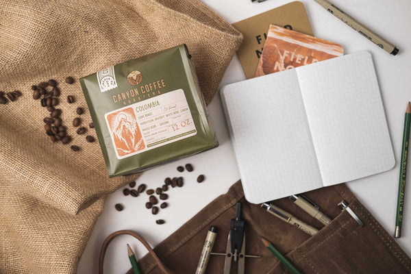 Adventure themed flat lay with bag of Canyon Coffee Roasters coffee