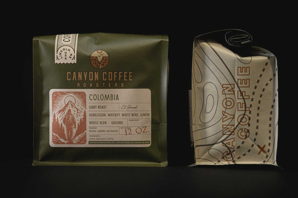 Two bags of Canyon Coffee Roasters coffee on a black background