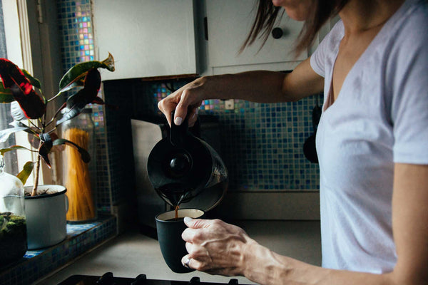 Woman pouring cup of Canyon Coffee Roasters coffee