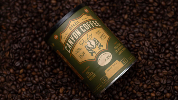 Canyon Coffee Roasters coffee tin on a background of roasted coffee beans